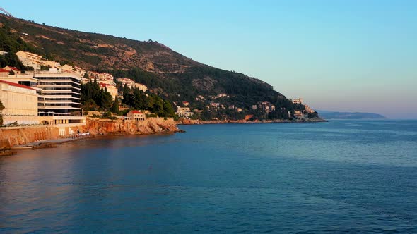 Drone rising over the Adriatic sea and revealing the Dubrovnik modern city alt