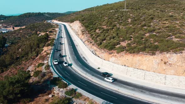 Aerial view of the mountain high-speed highway. Cars are driving along a mountain road. alt