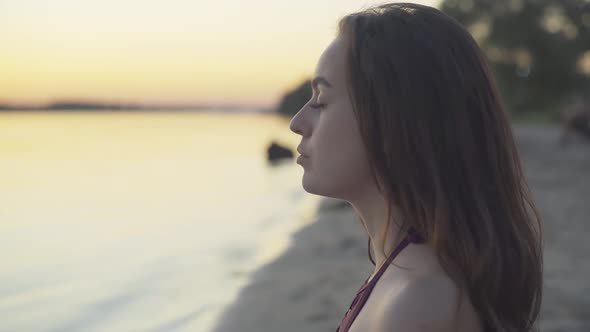 Close-up Face of Concentrated Young Beautiful Woman Breathing in and Out Raising Hands. Portrait of alt