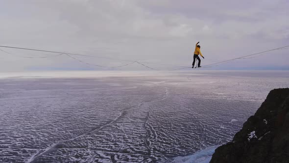 Balance on the Horizon. Slackliner Is on a Tight Rope and Falls.