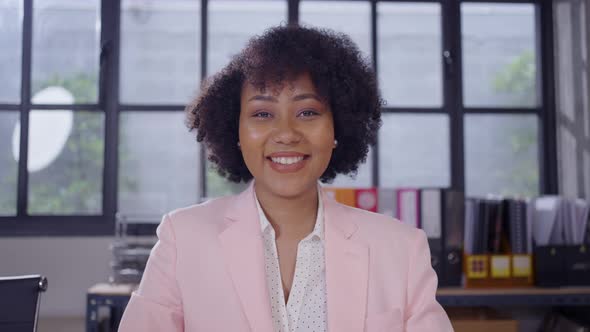 Close up portrait young african woman smiling in office alt