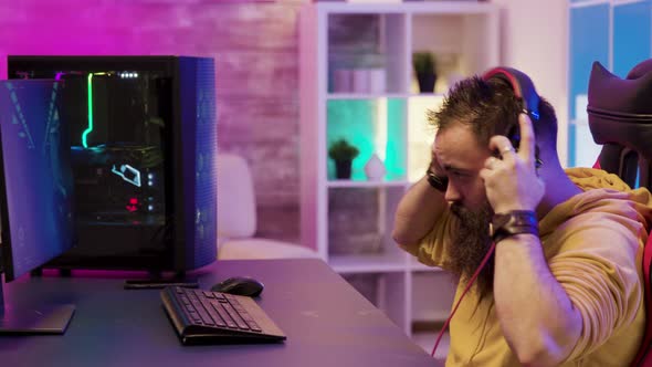 Concentrated Man Playing Video Games on Pc in His Room alt