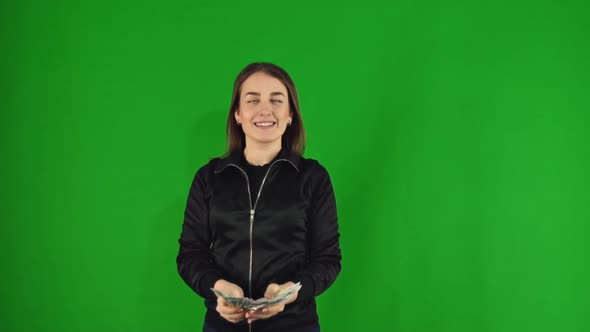 Happy Woman Throws Up Money and Smiling on Green Screen