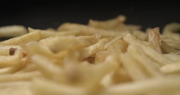 French fries with salt close up slow motion studio, tasty fast food