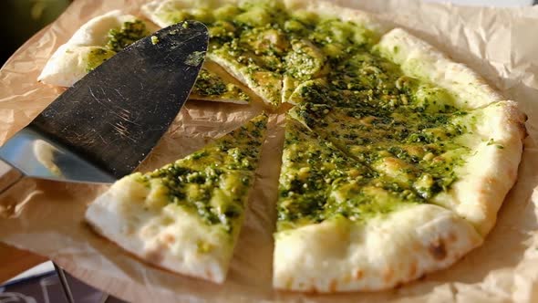 Closeup vegetarian pizza served next to serving trowel lies on paper