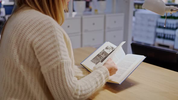 Female Hands Closeup Quickly Flipping Through the Pages of a Paper Book alt