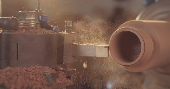 Man working on a wood lathe creating art - slow motion macro shot alt