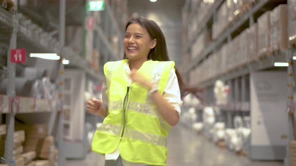 Funny female warehouse worker dancing in warehouse and having fun ...