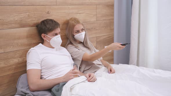 Young Couple is Quarantined at Home Watching Tv