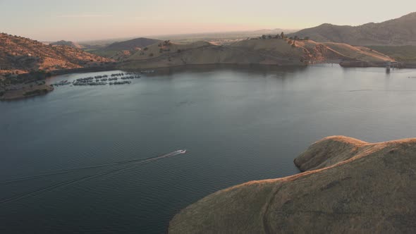 Aerial Drone Tracking Shot of a Boat on a Beautiful Mountain Lake (Lake Kaweah, Visalia, CA)