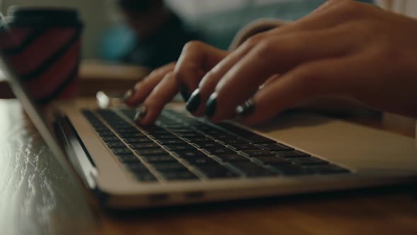 Young Woman Work on Laptop in Cinematic Cafe