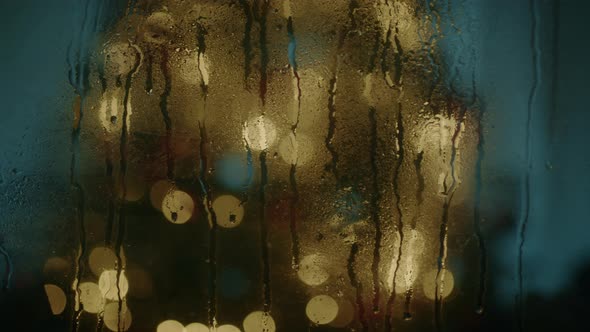 Christmas tree behind wet window alt