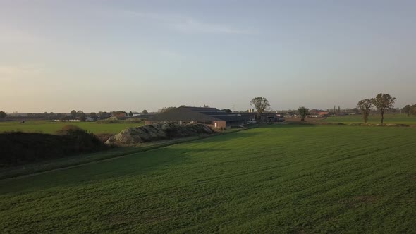 Aerial Cinematic Clip Drone Flying Over a Farm Field During Sunset alt
