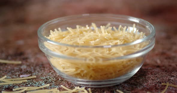 Dry Pasta Vermicelli in Glass Bowl Slowly Rotating alt