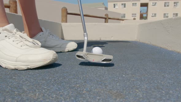 Close Up of the Golf Stick Hitting a Golf Ball  Mini Golf alt