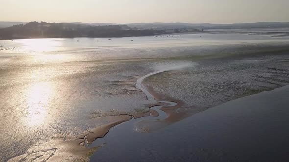 Breathtaking view from the sky of coastal town in South England. Water and sand formations are visib alt