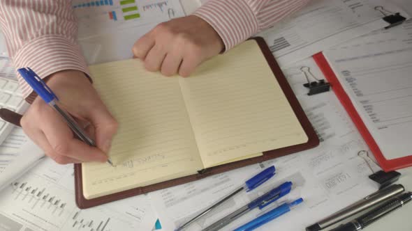 Businessman Holding Pen Writing New Appointments Information alt
