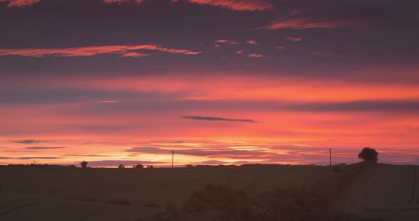 Soft Cloud Layers Change In Distance Over Field With Pylons Time Lapse alt
