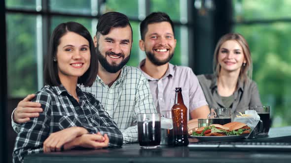 Diverse Group of Attractive Young Friend Posing at Sport Bar with Beer Fast Food Enjoying Weekend alt