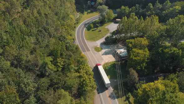 Semi Truck Driving On Curvy Country Road alt