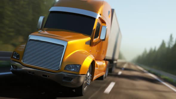 Semi truck with trailer driving through the green forest during sunny day. 4K alt