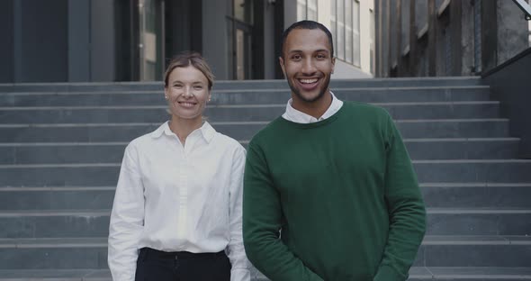Positive Business Couple Posing Rejoicing OutdoorsStanding Together at Urban Street alt