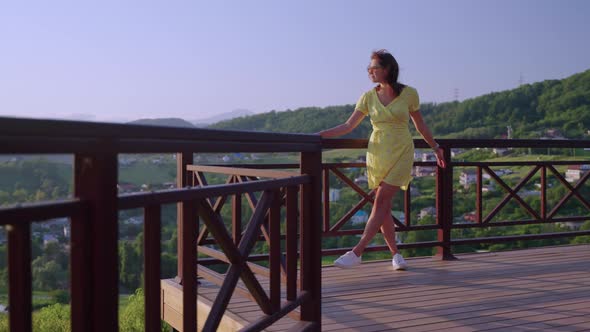 Carefree Woman Admiring Village Scenes alt