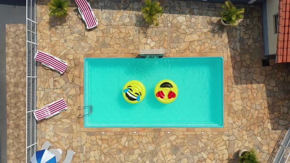 Smile emoji icon floating at swimming pool at countryside alt