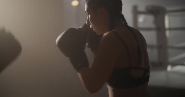 Young Woman Athlete in Boxing Gloves and Sport Clothes is Boxing With Her Skillful Trainer alt