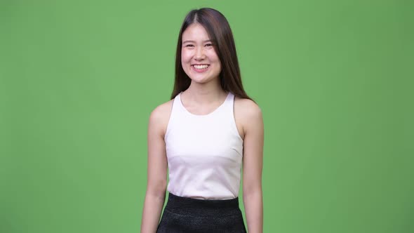 Young Happy Beautiful Asian Businesswoman Thinking