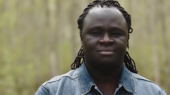 Portrait Shot of Smiling African Back Man in the Park alt