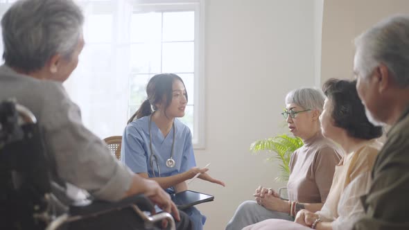 Asian senior people sit in a circle in a nursing home and use stethoscope  listen the heart beating