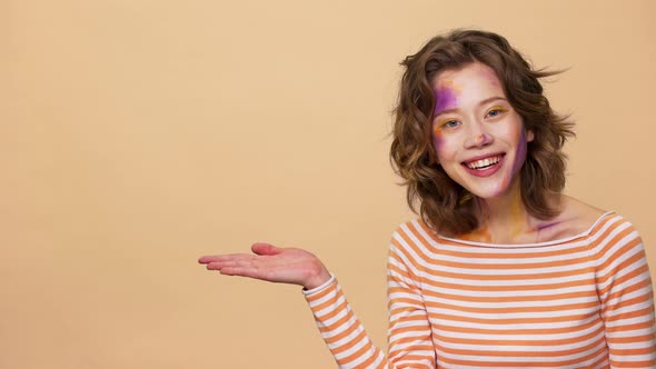 Portrait of Pretty Woman with Brown Hair Smiling and Presenting Copy Space Text or Product on Palm alt