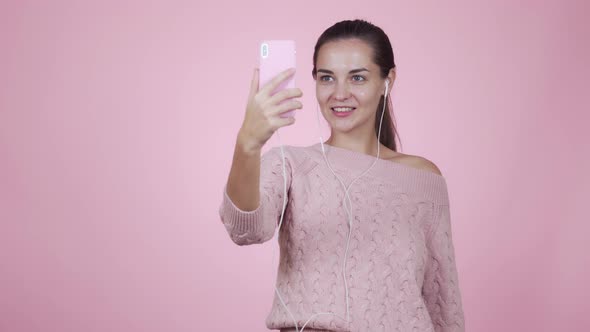 Girl Blogger Makes Video Story Using Mobile Phone Isolated on Pink Background alt