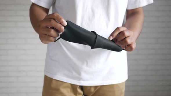 Man Hand Holding Surgical Face Mask Close Up alt