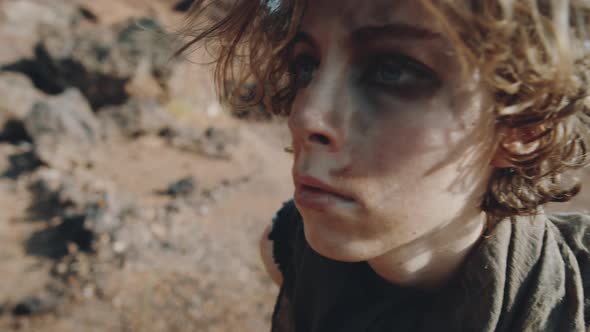 Woman with Dirt on Face Walking in Post Apocalyptic World alt