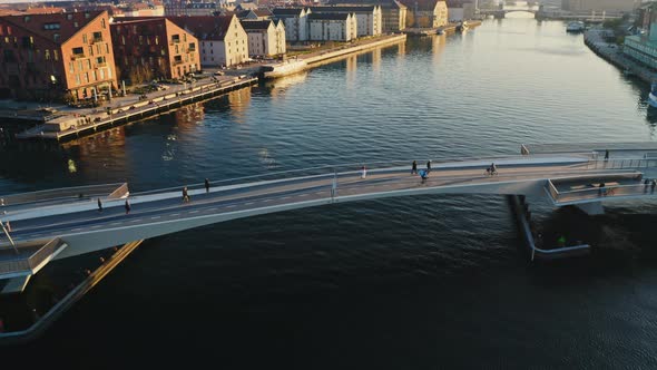 Bridge Along Canal Waters in Denmark and Townhouses in Background alt