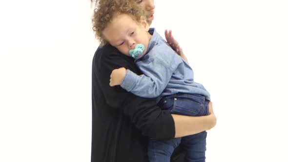 African American Mother Is Shaking a Small Child in Her Arms. White Background alt