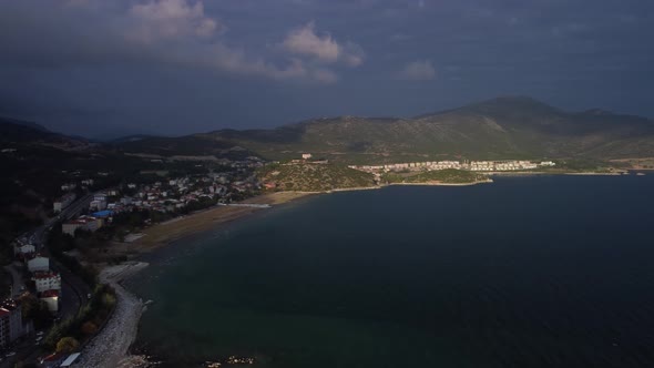 Long Coast with Town and Mountain Ridge are Filmed By Drone at Warm Summer Day alt
