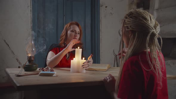Female Psychic Seeing Future with Candle Lights alt