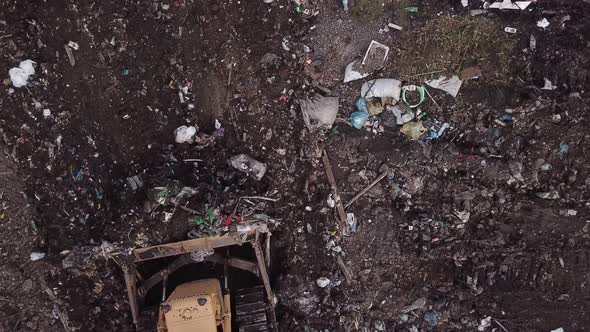 Bulldozer Collects Garbage Into a Pile alt
