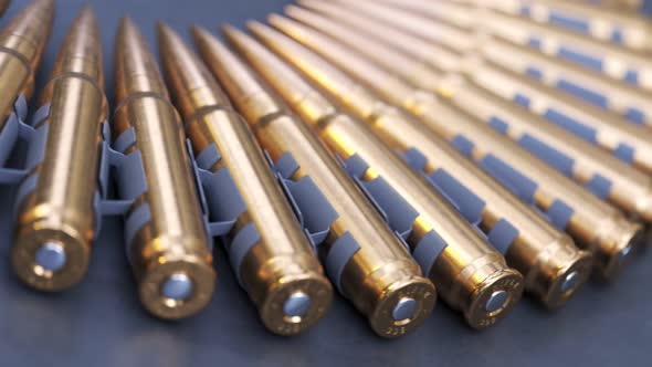 Sniper or machine gun ammo belts on a production line. Deadly ammunition. alt