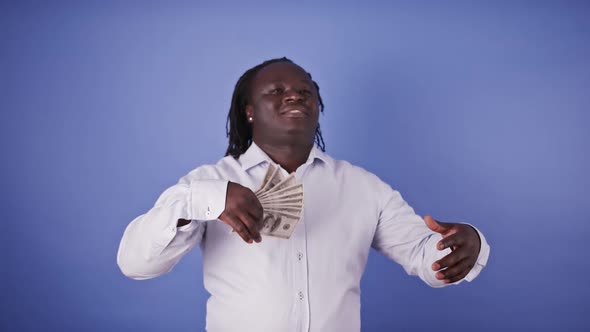 African Man Using Bunch of Money Notes As Fan. Rich Man, Won Lottery alt