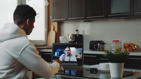 Black Man Making Video Consultation with Female Doctor on Computer alt