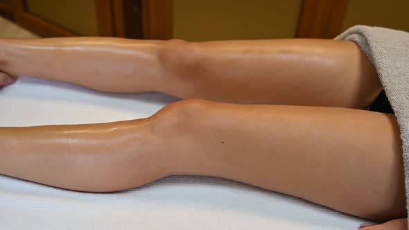 Woman Getting Legs Massage in Spa Salon