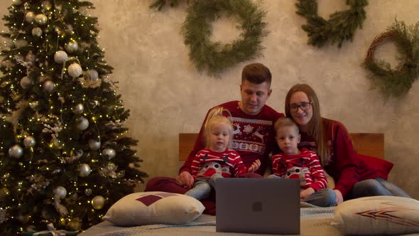 Happy Family Watching Movie Together at Christmas