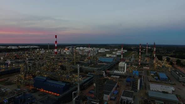 Aerial view of the petrochemical oil refinery plant shines at night alt