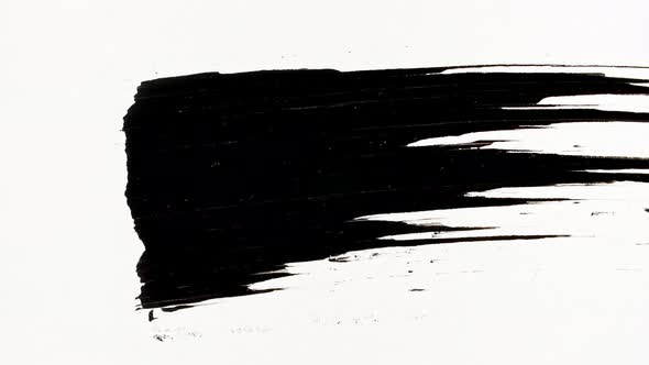 Macro Shot and Slow Motion of a Black Mascara Isolated on White Background alt