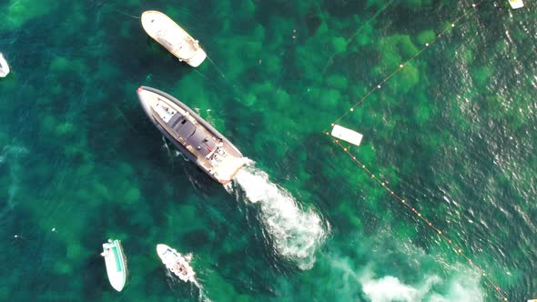 Moving Speedboat Between Other Boats Overhead Aerial View alt