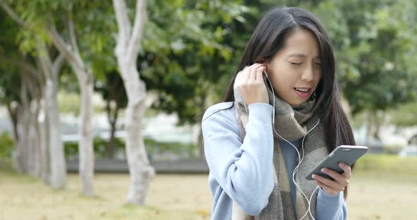 Woman Listen to Music on Cellphone by Earphone alt